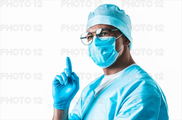 Portrait of a doctor on a white background. He optimistically raises his finger up. The concept of new ideas in medicine.