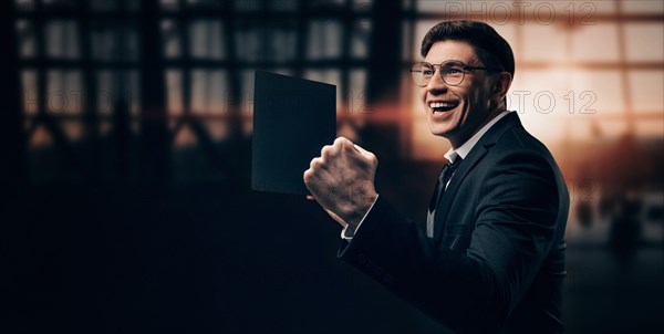 Portrait of a man in a business suit. He is standing at the airport with his hands up. VIP transportation. Private airlines. Charter flights.