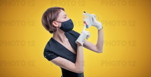 Portrait of an elegant beautiful girl with a set of nail palette in hand. The concept of beauty salons