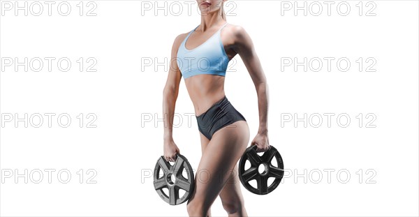 No name portrait of a tall athletic woman with weight plates in her hands. The concept of sports