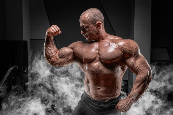 Professional weightlifter posing in the gym. Classic bodybuilding.