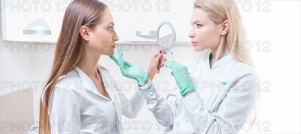 Portrait of two girls in white coats. The concept of cosmetology