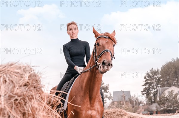 Beautiful woman rides a horse. Equestrian sport concept.