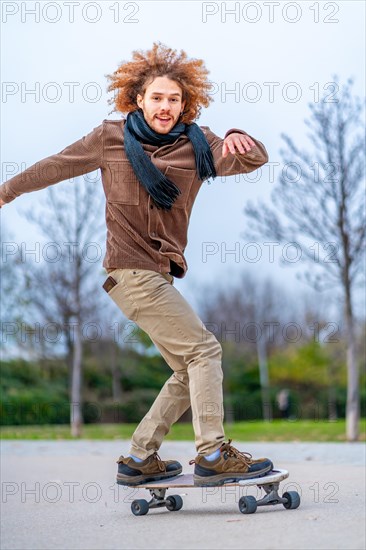 Man skating and proving balance in a skate board in a urban park