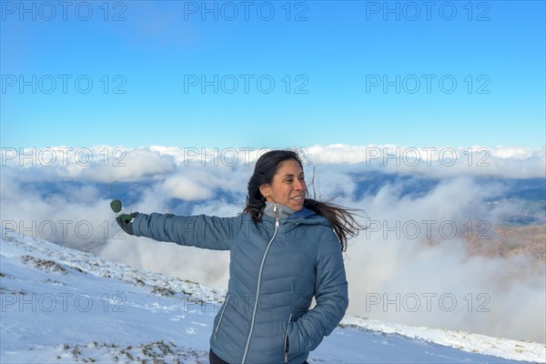 Portrait of latina woman in the snow above the clouds