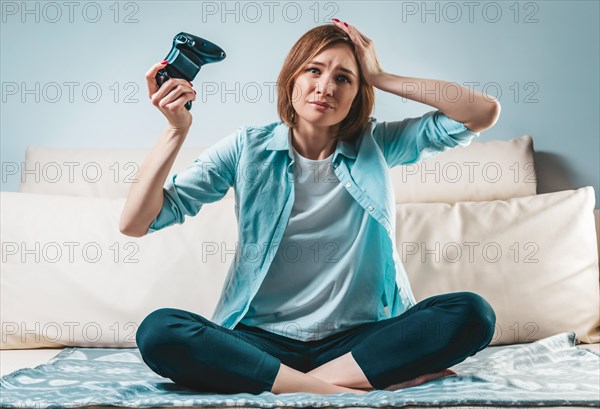 Portrait of a girl with a joystick in her hands. The concept of video games