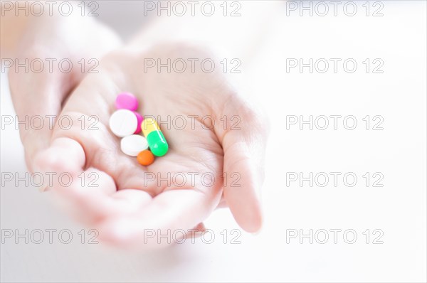 Image of pills on a female palm. The concept of medicine