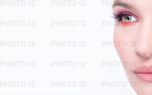 Portrait of a beautiful girl with provocative makeup. White background. Beauty concept. High quality