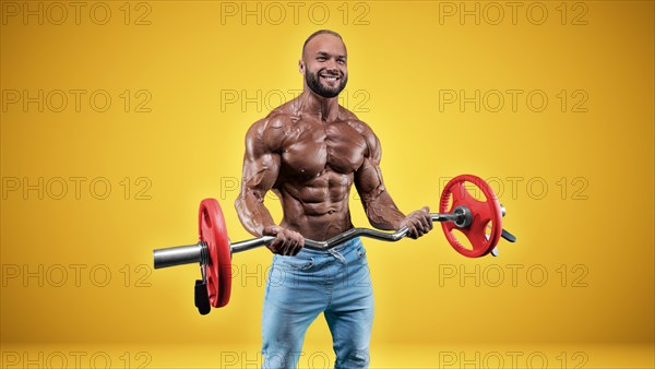 Isolated professional sportsman on a yellow background. Bodybuilding concept. Panorama. Advertising of a gym and sports nutrition.