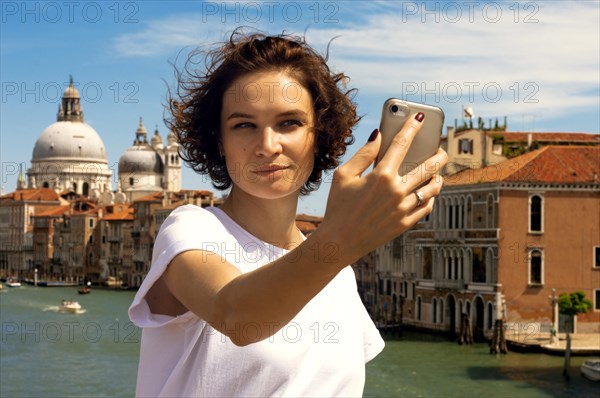 Portrait of a charming girl with a view of santa maria della salute. Travel and vacation concept.