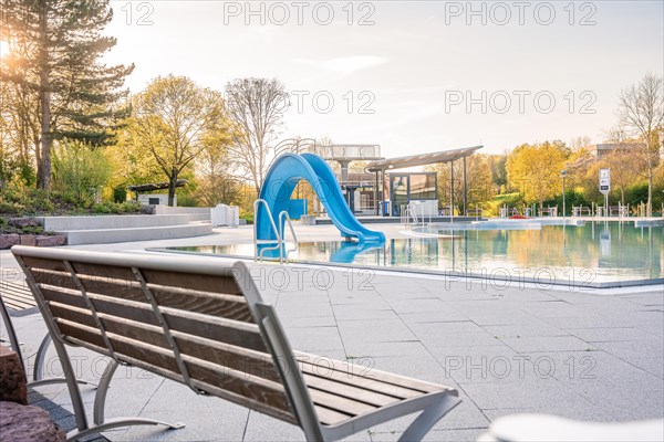 Empty bench conserved swimming pool with water basin in a quiet atmosphere
