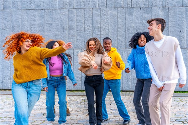 Free style dance of joyful multi-ethnic and diverse friends in the street