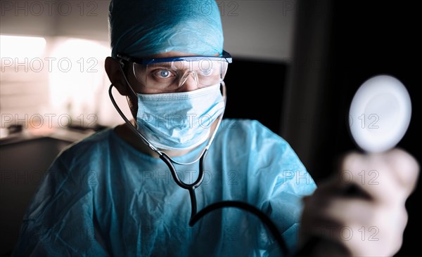 Doctor male surgeon in uniform working with a stethoscope in a medical office