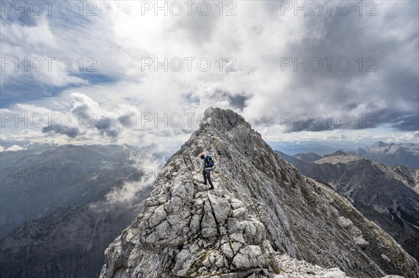 Mountaineer on a narrow rocky ridge