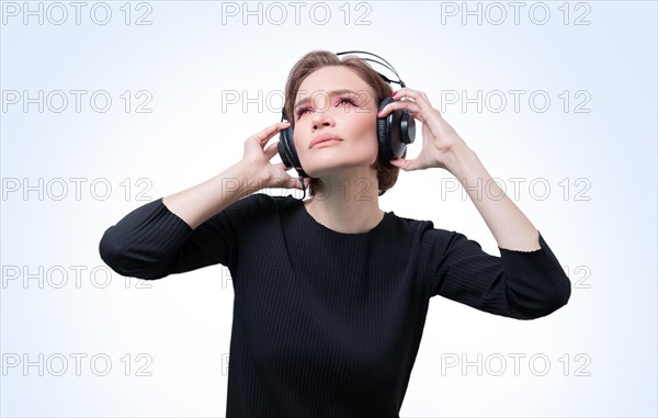 Portrait of a woman in professional headphones. White background. Dj concept.