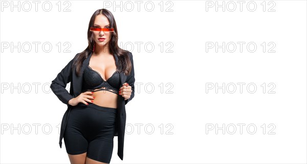 Beautiful tall pregnant brown-haired woman posing in the studio on a white background. Maternity lingerie concept.