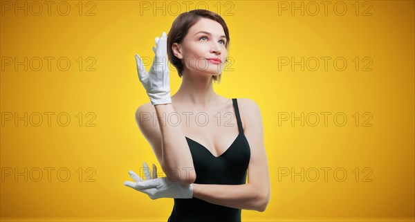 Portrait of a beautiful woman in a black dress and white gloves. Jewelry store concept. Sales consultant.