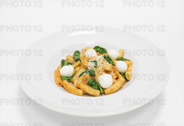 Gourmet pasta with basil and mozzarella balls. Top view. White background. Healthy eating concept.