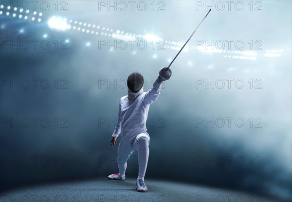 The fencer moves forward with a sword in his hand. Sport concept.