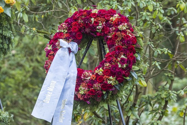 Funeral wreath with flowers at a grave