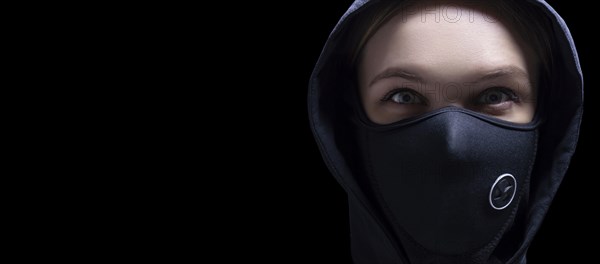 Portrait of a girl in a protective mask. The concept of the fight against the epidemic.