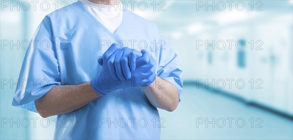 The doctor in a medical center clasped his hands together. Medicine concept.