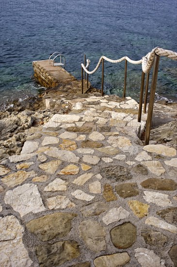 Footbridge leading into the sea