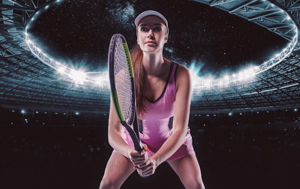 Portrait of a tennis player in a pink dress against the background of a sports arena.