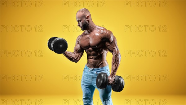 Isolated professional sportsman on a yellow background. Bodybuilding concept. Panorama. Advertising of a gym and sports nutrition.