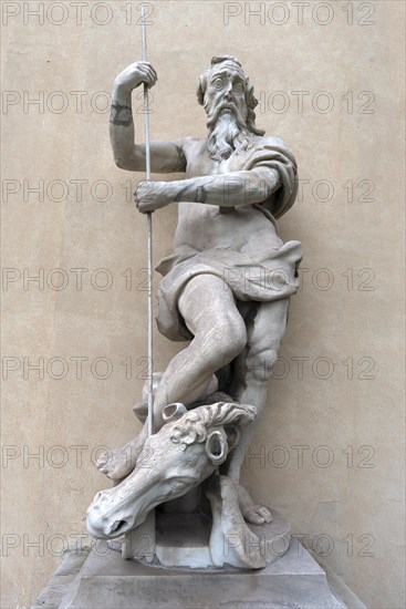 Large male sculpture with horse in the garden of Palazzo Reale