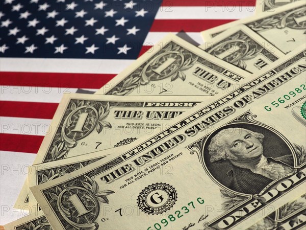 Dollar notes and flag of the United States