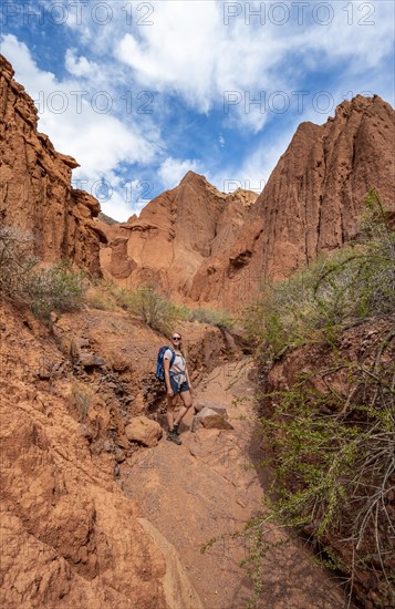 Climber in a canyon with a dry stream bed