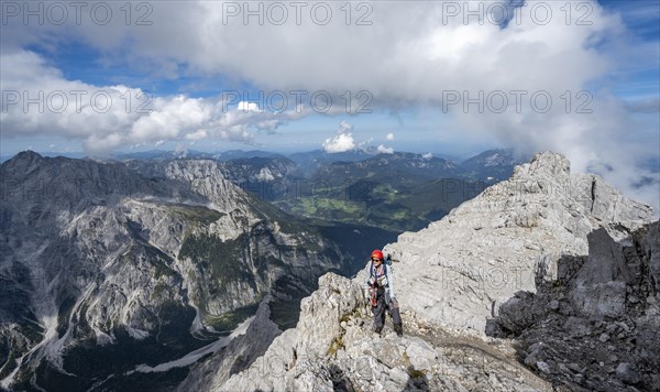 Mountaineer on a narrow rocky ridge