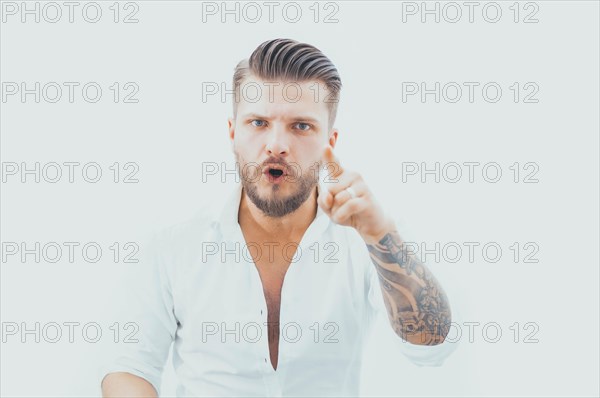 Stylish bearded man pokes a finger at the camera. The concept of choice