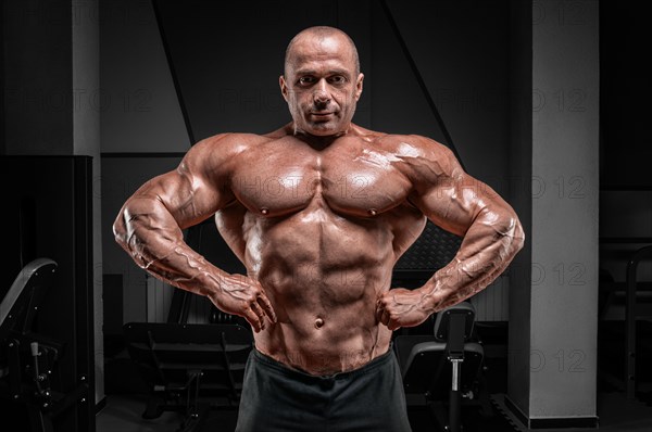 Professional weightlifter posing in the gym. Classic bodybuilding.