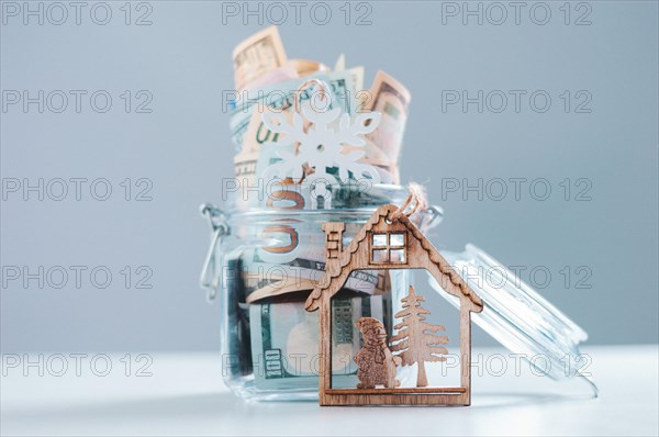 Glass piggy bank full of money. Christmas and New Year concept. Gift expenses.