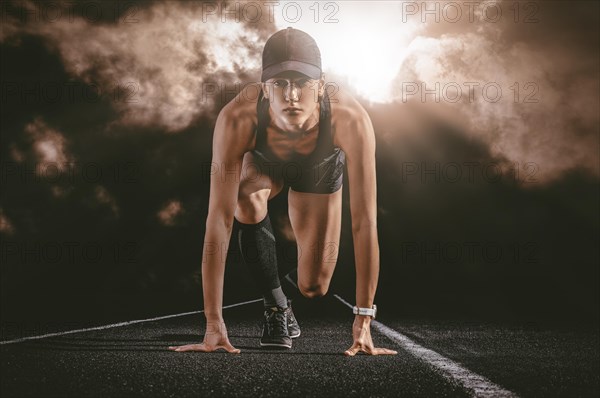 Professional runner stands on the track and prepares for the start of the race. Sports concept.