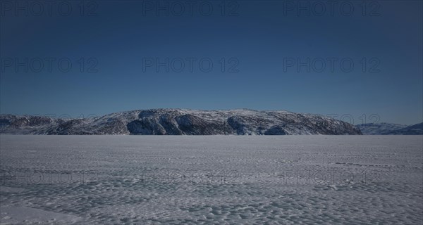Hill on the shore of the icy fjord Kangerlussuaq