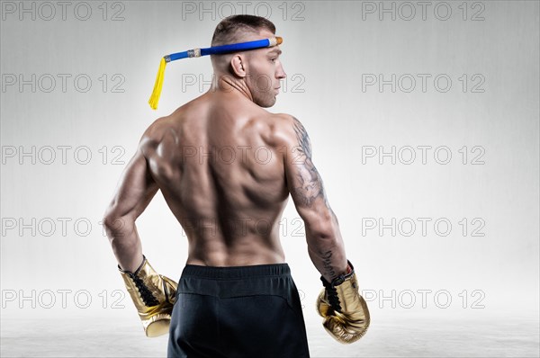 Portrait of a Thai boxer. Back view. Mixed martial arts concept. Competitions and tournaments