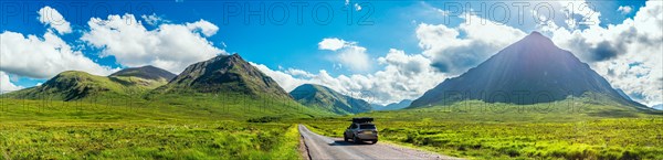 Panorama of Glen Etive and SUV BMW X3 with a roof tent