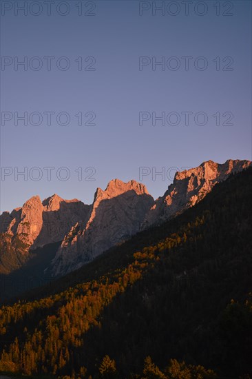 The last rays of sunlight illuminate the peaks of the Wilder Kaiser