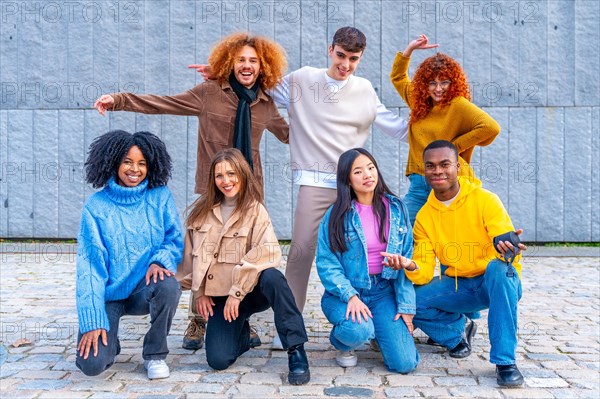 Fun group of friends posing crouching and standing in the street