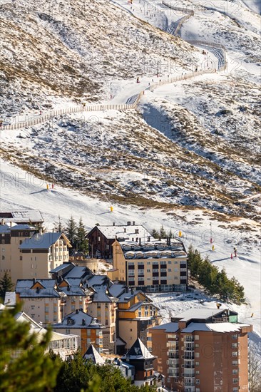 Aerial view of ski resort hotels and slopes with skiers