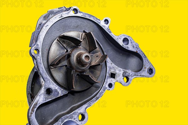 Car water pump on yellow isolated background