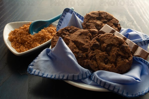 Delicious cookies on a white dish paired with brown sugar