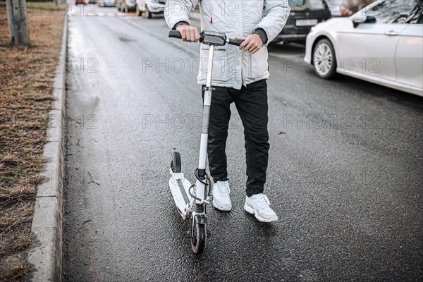 Riding an electric scooter in cold weather around the city