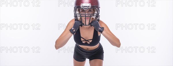 Woman in the uniform of an American football team player posing on a white background. Sports concept.