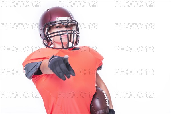 Woman in the uniform of an American football team player points her finger at the camera. Sports concept.