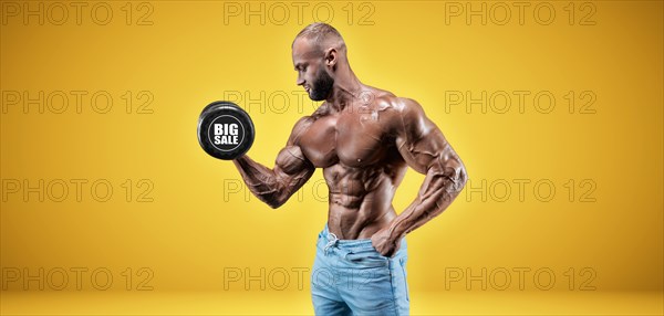 Isolated professional sportsman on a yellow background. Bodybuilding concept. Panorama. Advertising of a gym and sports nutrition.