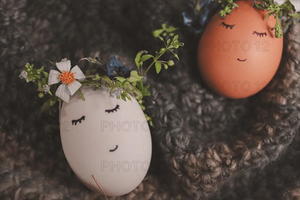 Playful painted eggs with faces and floral decorations